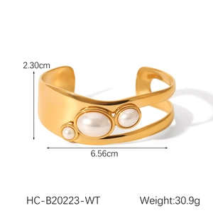 Detail of open gold cuff bangle featuring hollow design and natural pearls 30.9g