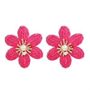 Handmade woven raffia flower earrings with pearls and rhinestones on a white background