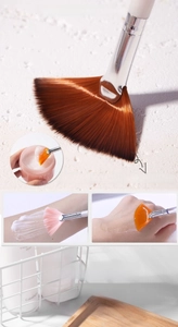 Macro shot showing application of creams and liquids using a soft fan facial mask brush