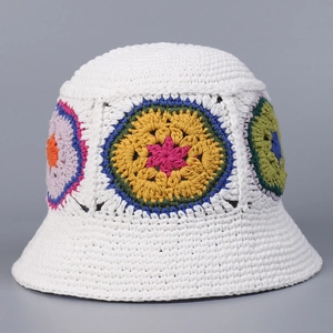 Detail of handmade crochet bucket hat with colorful floral patterns and cotton knit texture