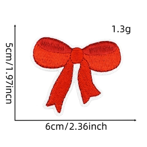 Detailed close-up of red embroidered bow patch with 6cm x 5cm dimensions and fine texture