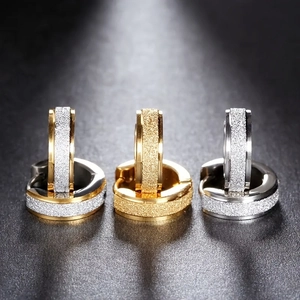 Unisex frosted stainless steel hoop earrings in gold and silver finish on black background