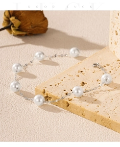 Detail of S925 sterling silver pearl bracelet with lobster clasp on natural stone background