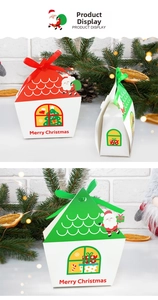 Close-up of house-shaped Christmas gift boxes in red and green with festive ribbons