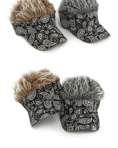 Detail of wig sun visor with paisley patterns and fluffy synthetic hair in two colors