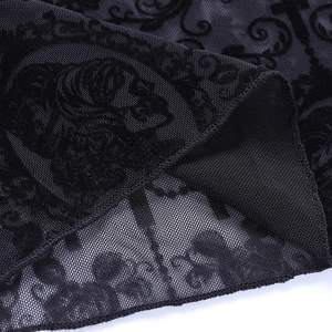 Detailed macro view of black gothic flocked floral pattern on semi-sheer lace fabric