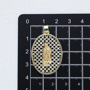 Gold plated oval Virgin Mary pendant with cubic zirconia stones on measuring mat