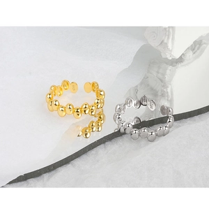 Detail view of S925 sterling silver bean rings in gold and silver finish with hallmark