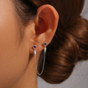 Close-up of S925 sterling silver chain earrings with heart-shaped purple gemstones