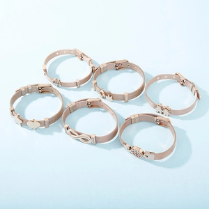 Rose gold mesh bracelet with diverse charms including infinity and life tree symbols