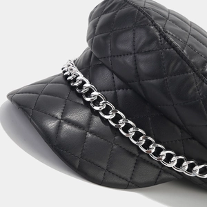 Black quilted faux leather newsboy hat with silver chain detail in a stylish navy style