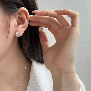 Close-up of S925 sterling silver square stud earring with brilliant zircon halo