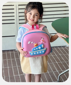 Pink EVA hard shell kids backpack with 3D cartoon ship design worn by a young girl