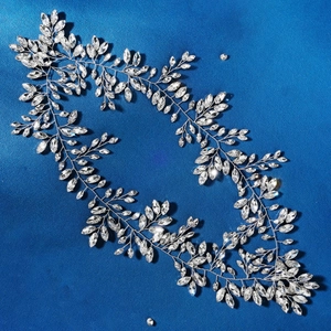 Detailed macro view of silver floral crystal headband with rhinestone leaf patterns