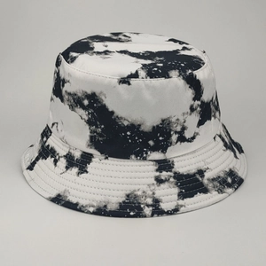 Detail of double-sided tie-dye bucket hat featuring reinforced stitching and cow print pattern