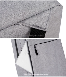 Detail of reinforced stitching and front zipper pocket on grey laptop backpack
