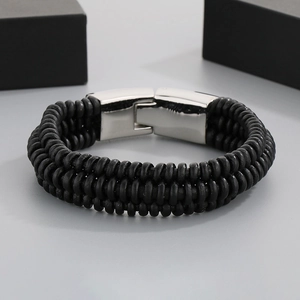 Close-up of black braided leather bracelet with a polished silver stainless steel clasp