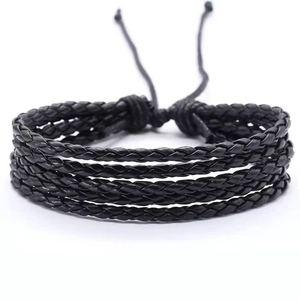 Detail of black multi-strand woven leather bracelet with adjustable drawstring closure