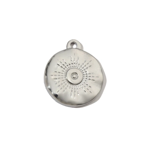 Detail of silver round sunburst pendant with radial texture in stainless steel