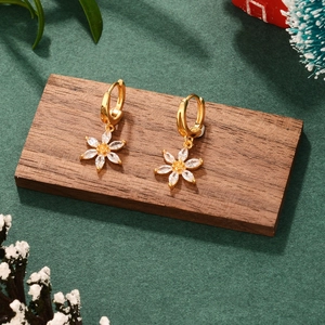 Elegant French gold flower earrings with crystals on wood block with festive decor