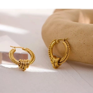 Twisted gold hoop earrings with sliding charms, made of polished stainless steel