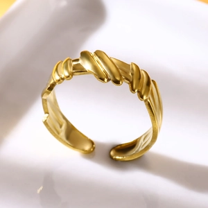 Close-up of gold-plated stainless steel wavy cross ring with adjustable open design