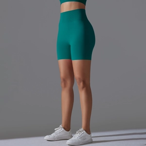 Side view of emerald green high-waisted yoga shorts with rib-knit texture and lifting effect