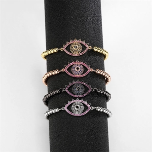 Detailed view of four adjustable evil eye beaded bracelets in gold, rose gold, black, and silver