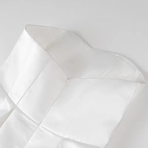Detail view of white strapless dress featuring internal boning and hidden back zipper
