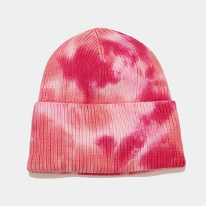 Detail of soft tie-dye knit beanie in pink tones with textured core-spun yarn finish