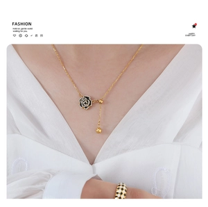 Detail of rose pendant necklace with crystal inlay and sliding adjustable gold bead