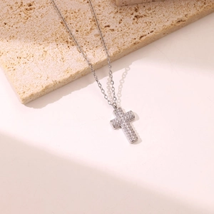 Minimalist silver cross pendant necklace with micro-paved zircons on a delicate chain