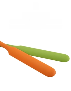 Macro detail of food-grade silicone spatulas in vibrant orange and green colors