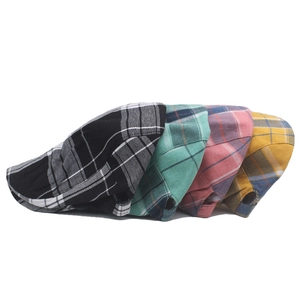 Detail of colorful plaid newsboy caps showcasing high-quality cotton texture and patterns