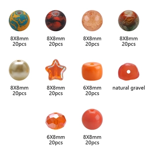 Macro view of 10 orange and blue DIY jewelry beads in round, star, and faceted shapes