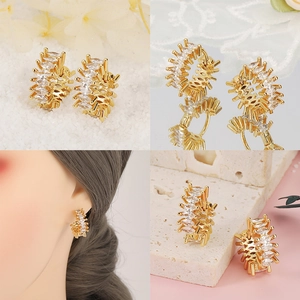 Detalle de pendientes de aro bañados en oro de 18K con circonita marquesa en varios fondos