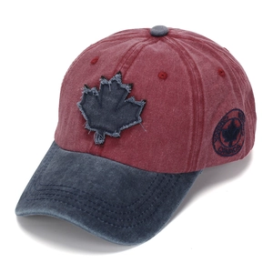 Vintage washed cotton baseball cap featuring a blue maple leaf patch and curved brim