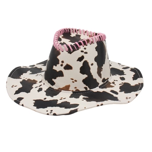 Cow print western cowboy hat with pink braided stitching detail on white background