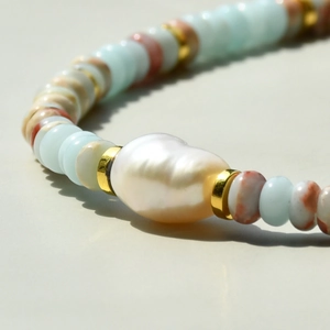 Macro view of Shoushan stone beads and baroque freshwater pearl with gold spacers