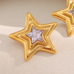 Macro detail of 18K gold plated stainless steel star stud earrings with zircon stones