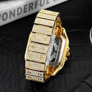 Macro shot of gold square luxury watch with iced-out diamonds and side detail