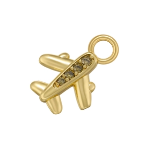 Detailed close-up of a gold-toned airplane pendant with embedded olive green zircons