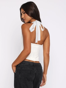 Chic white halter neck cutout top with back bow tie detail and slim fit style