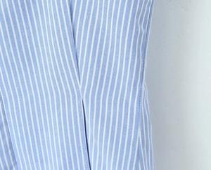 Close-up of blue and white striped fabric texture and detailed stitching of the camisole