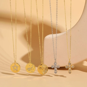 Row of gold and silver pendants with star, moon, and sun motifs and tiny zircons