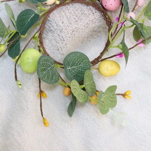 Easter egg wreath with eucalyptus leaves and colorful speckled berries on vine base