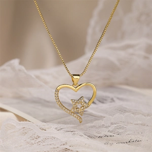 Close-up of heart and star pendant necklace with cubic zirconia in gold finish