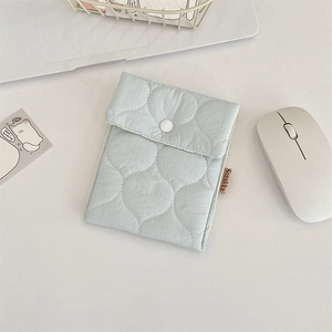 Detailed view of a light blue quilted storage bag for lipsticks and sanitary pads