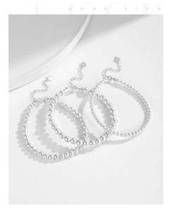 Detailed view of s925 silver pearl bracelets with heart pendant on white background