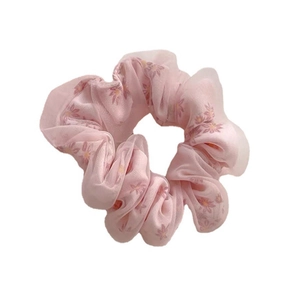 Elegant pink mesh hair scrunchie with floral pattern for bun hairstyles on white background